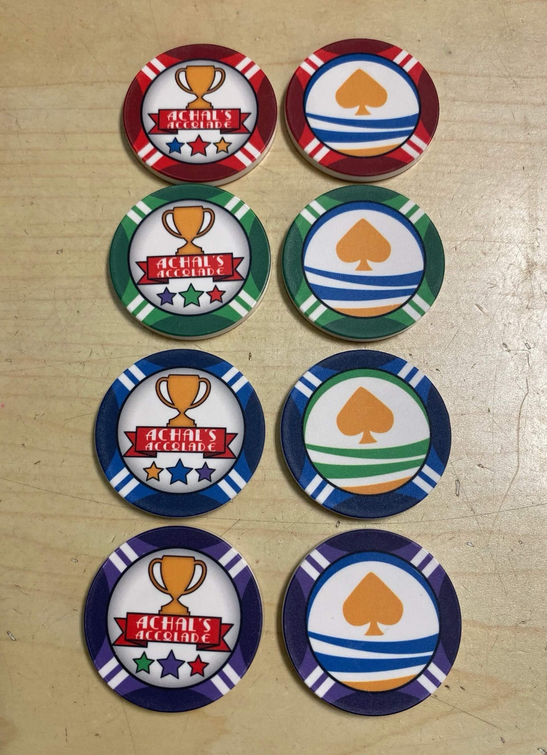 Aurora Poker Gear Custom Reward Token Chip Set for Client - Achal's Accolade - Set of ceramic reward tokens made by Aurora Poker Gear, feature company logo and text, come in various colors, given for merit and achievements.