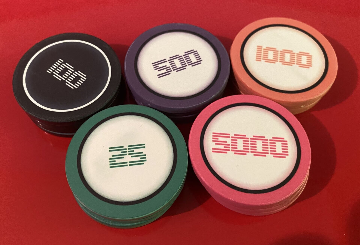 Aurora Poker Gear Custom Game Tokens - Kevin McKinley Minimalist Video Game-themed Poker Chips - Set of custom ceramic video game style poker chips made by Aurora Poker Gear, feature minimalist, retro font and pixel art graphics in red, blue and yellow colors.