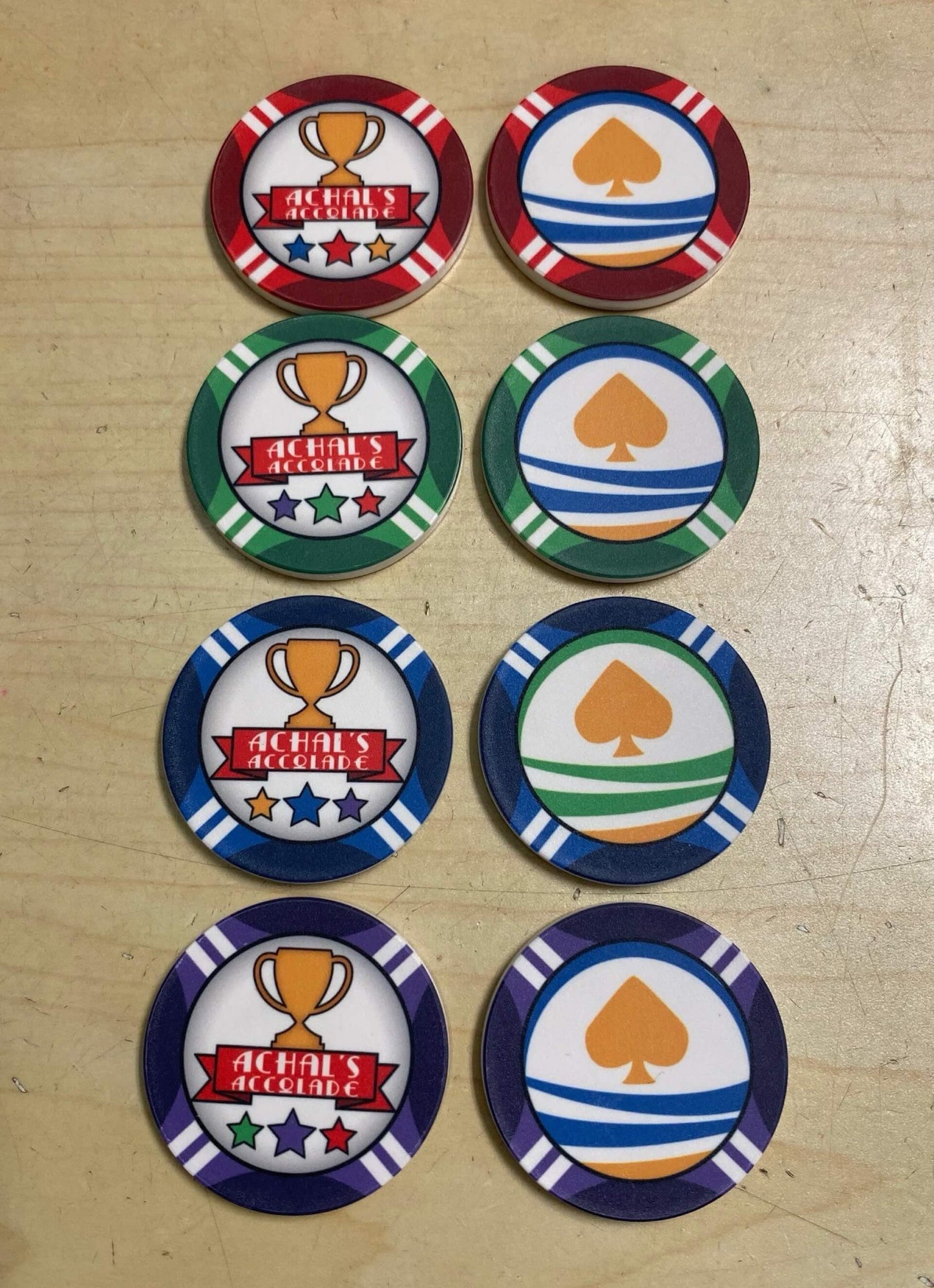 Aurora Poker Gear Custom Reward Token Chip Set for Client - Achal's Accolade - Set of ceramic reward tokens made by Aurora Poker Gear, feature company logo and text, come in various colors, given for merit and achievements.