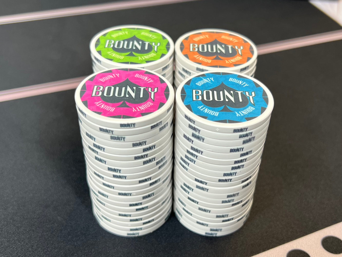 A straight-on view of the Havoc Bounty poker chips stacked up. The colors are so bright, they almost seem to glow on the table, which makes it easy to keep them separate from your poker tournament chips.