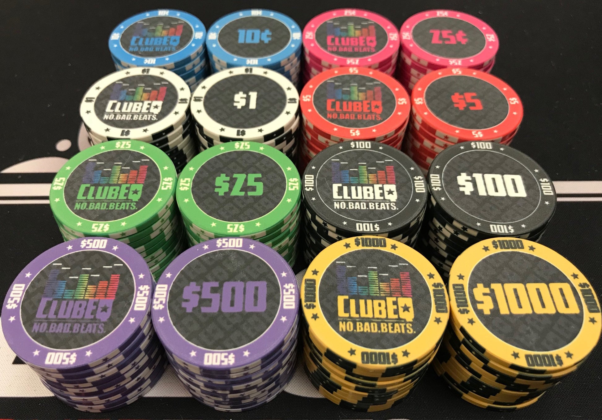 Both faces of each ClubEQ chip. Side 1 shows the ClubEQ logo. Side 2 shows the denomination. Stock colors/denominations are: blue 10¢, pink 25¢, white $1, red $5, green $25, black $100, purple $500, and yellow $1000. Full-color graphics on rolling edges.